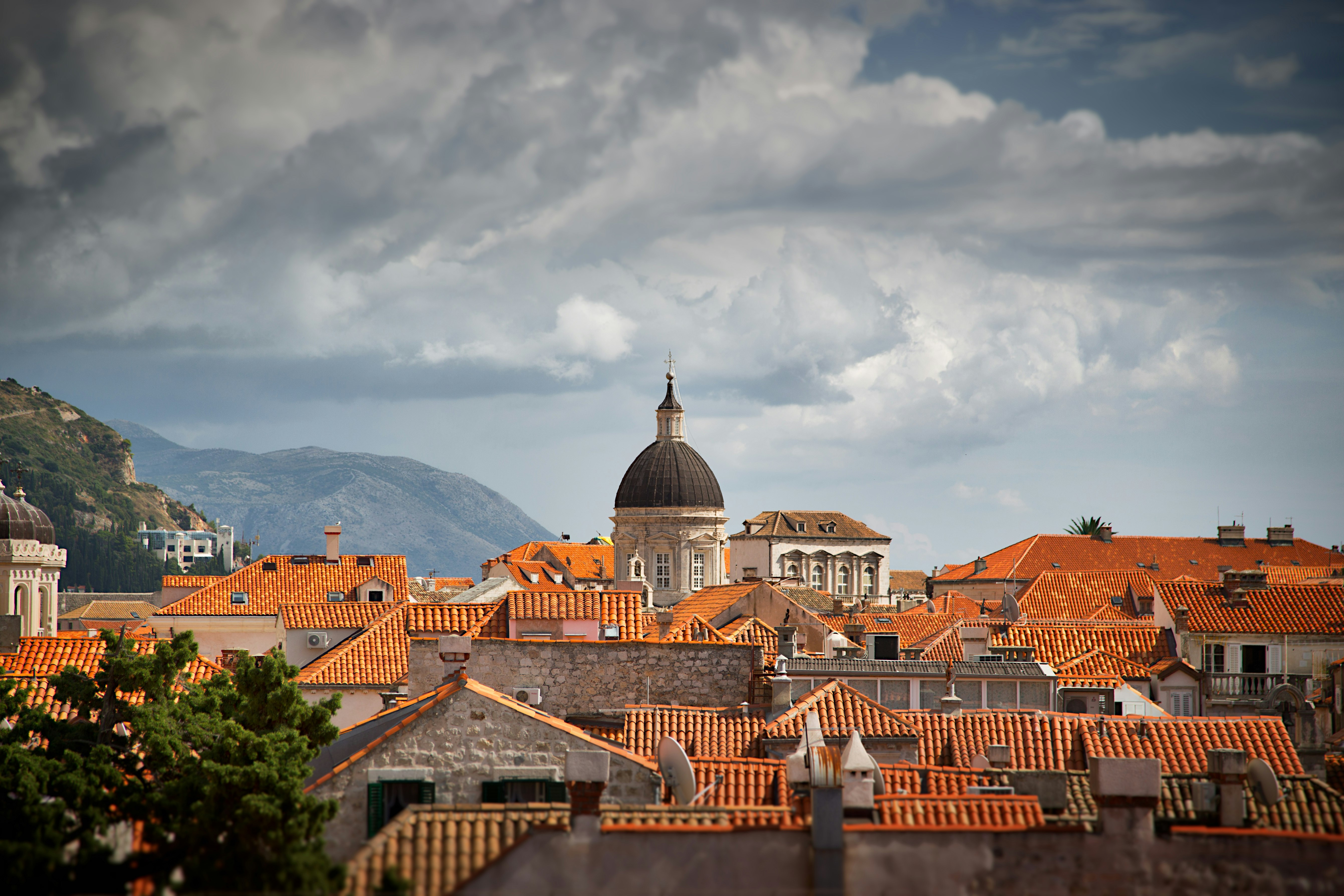 white concrete domed tower near houses at daytime